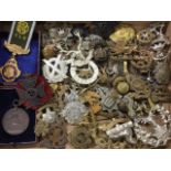 A collection of military badges, a cased 1940? bronze athletic medal, buttons, a gilt metal lodge