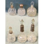Five miscellaneous Victorian glass scent bottles & stoppers with hallmarked silver mounts; and one