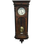 A large Victorian walnut cased Vienna style wallclock, with ebonised mouldings and applied