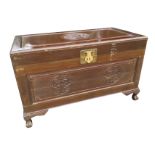 An eastern camphorwood box carved with tsuba style circular medallions, the interior with tray,