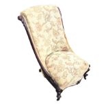 A nineteenth century mahogany nursing chair with acanthus leaf carving to angled curved back,