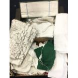 Two boxes of miscellaneous textiles including damask tableclothes, embroidery, table napkins,