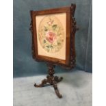 A Victorian rosewood screen, the acanthus carved frame with sliding insert around an oval finely