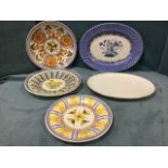 Three circular handpainted Spanish tin glazed delft style platters; an oval Limoges leaf moulded