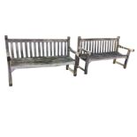 A pair of 5ft teak garden benches with slatted backs & seats, having shaped tapering arms on