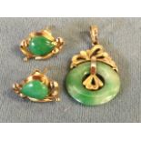 A Chinese jade ring mounted as a pendant in 14ct gold, with pierced leaf decoration; and a pair of