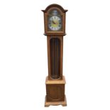 A reproduction oak cased grandmother clock with movement by Schmeckenbecher, the arched moulded hood