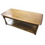 An Ercol oak coffee table with rectangular rounded top on baluster turned columns joined by