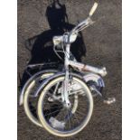 A Universal folding bicycle with sprung seat, two-tone tyres, pannier rack, Sturmey gears, pump,