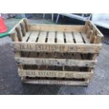 A set of four rectangular agricultural produce trays with slatted bases and side handles, stencilled