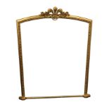 A large arched gilt overmantle - lacking mirror plate, the frame surmounted by carved giltwood plume