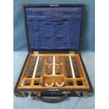 A cased optometrist set of glasses, the numbered lenses in fitted oak tray, the case with brass