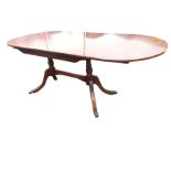 A Strongbow reproduction Georgian style yew dining table, the rectangular rounded top inlaid with