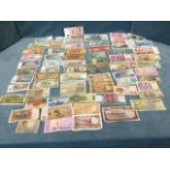 A collection of paper money - a wadge of over 75 used notes of various nationalities. (A lot)