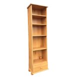 A faux pine cabinet with adjustable shelves above a bottom drawer, raised on bun feet. (16.75in x