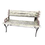 A small cast iron garden bench with slatted back & seat, having scroll cast arms on channelled sabre