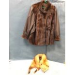 A lined ladies leather jacket with mink fur trim; and an amber fox stole with glass eyes. (2)