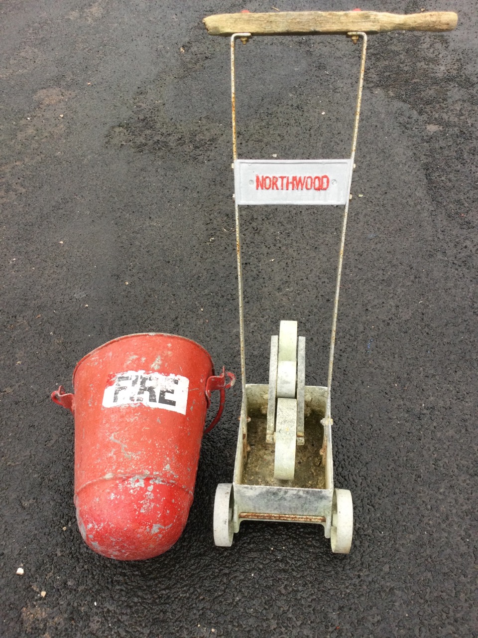 A Northwood field marker with rollers to tank on trolley wheels with wood handle; and a tapering