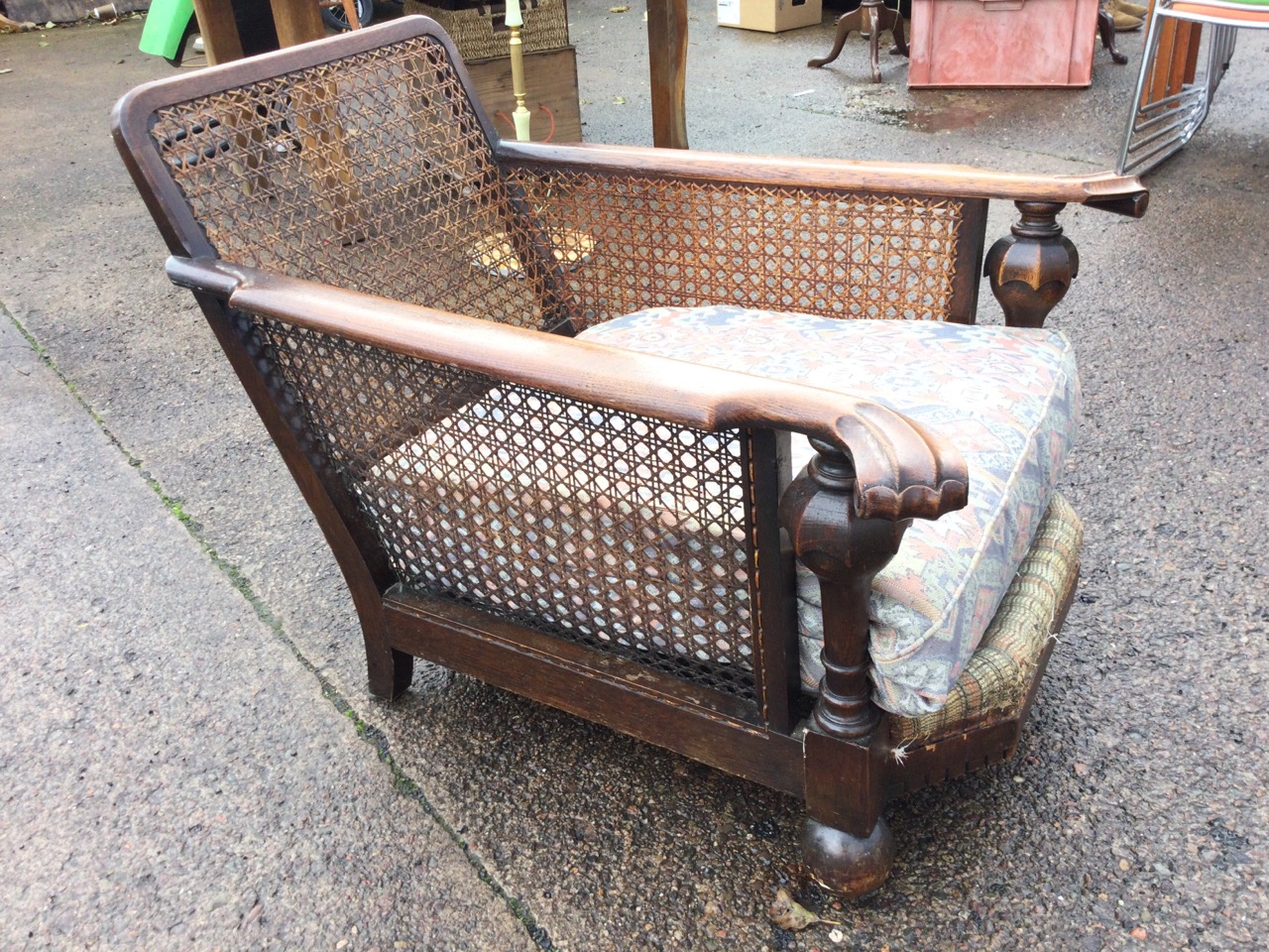 An oak begere armchair with cane back & sides having scroll carved platform arms supported on - Image 3 of 3