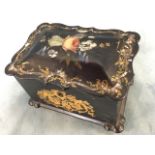 A Victorian papiémaché tea caddy inlaid with mother-of-pearl decoration and foliate scrolled gilding
