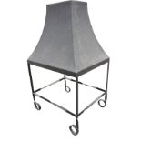 A wrought iron central fire canopy with rectangular tapering hood on supports with twisted frame and