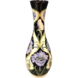 A large tapering Moorcroft tube-lined vase, decorated with blue stylised flowers and butterflies