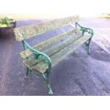 A Victorian rectangular cast iron garden bench with plank back and seat on leaf cast ends with