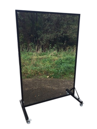 A dancers exercise mirror, the large plate in metal frame, raised on a stand with locking