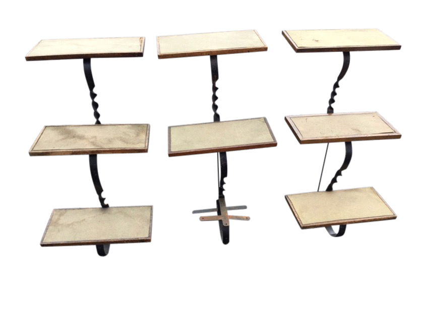 A set of three wrought iron display stands with graduated rectangular oak framed felt lined
