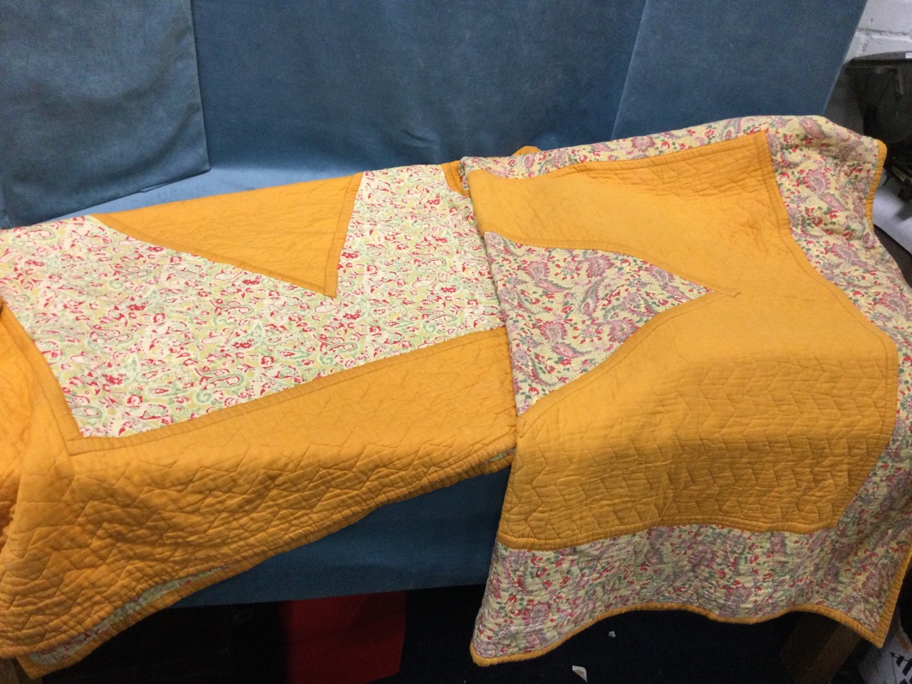 A pair of rectangular C20th cotton quilts sewn with paisley printed panels and borders on orange - Image 2 of 3