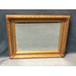 A rectangular mirror in ribbed foliate moulded gilt frame. (16.5in x 20.25in)