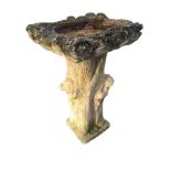 A composition stone garden birdbath moulded as logs, with square bowl on column cast with squirrels.