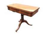 A Victorian mahogany turn-over-top tea table, the twin top supported on a turned column, with