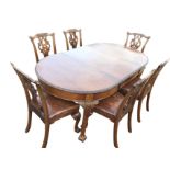 A late Victorian mahogany dining table & chair set, the extending table having rounded ends carved