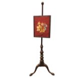 A Victorian mahogany firescreen, the column with ball finial mounted with adjustable moulded frame