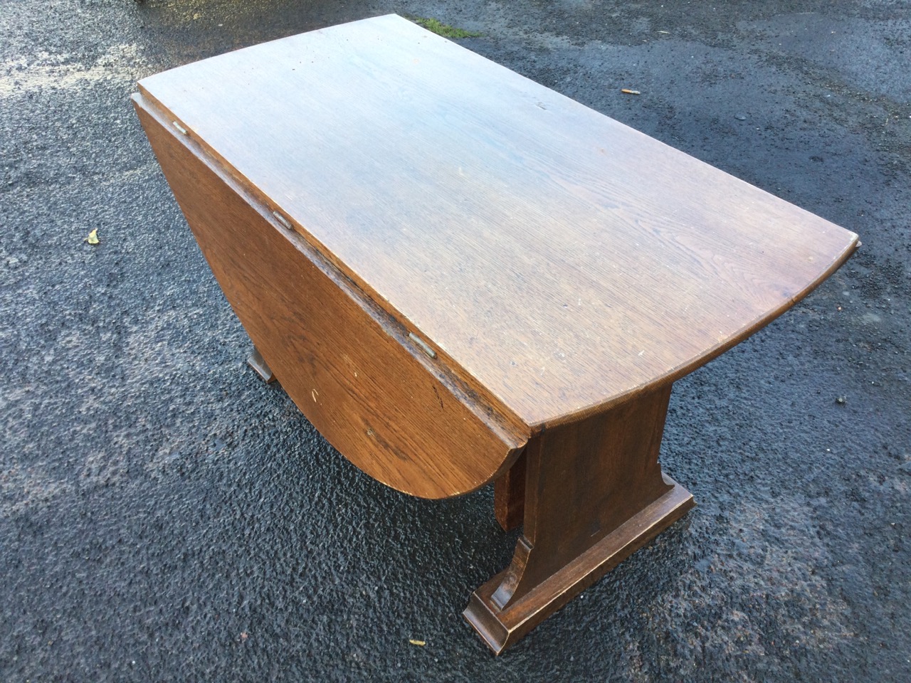 An oval oak coffee table with drop leaves on rectangular supports with batten feet, the gates with - Image 2 of 3