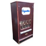 An 80s cigarette vending machine with perspex sign above four drawers with delivery compartment