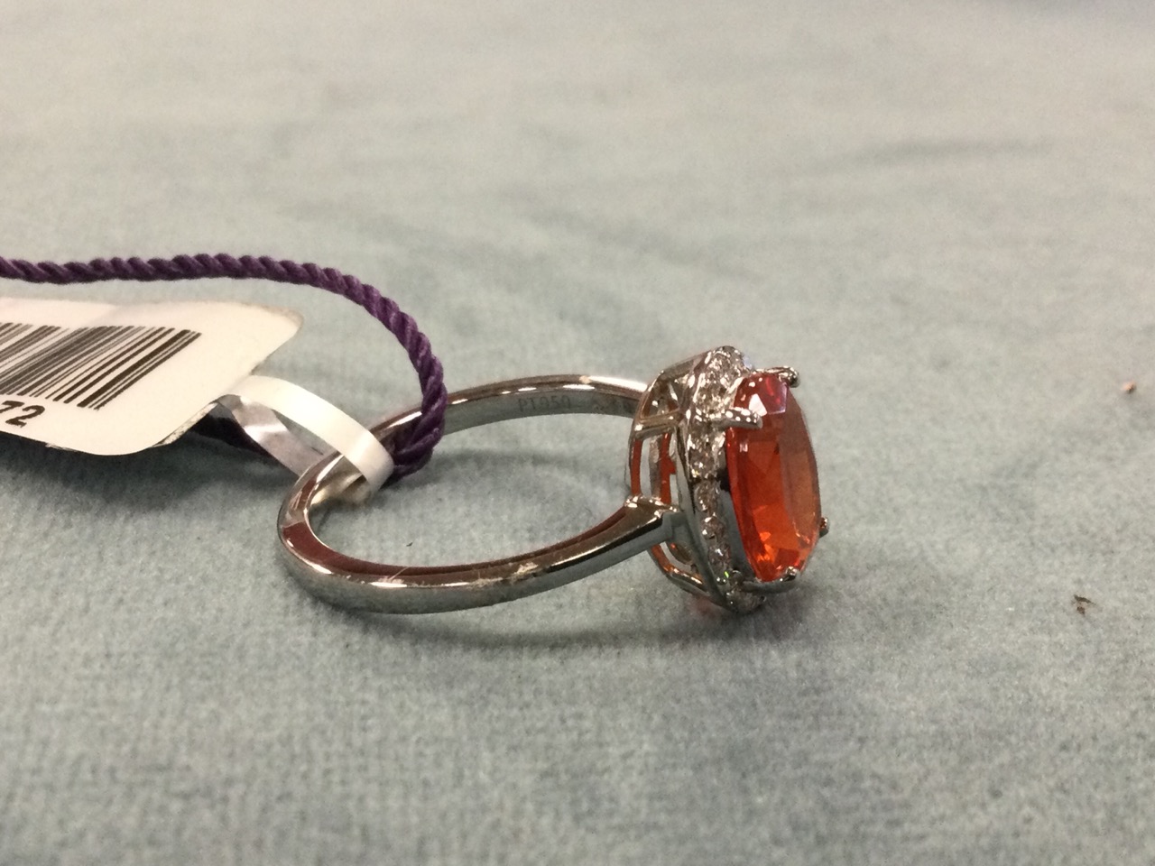 A platinum fire opal ring, the claw set oval Salamanca fire opal framed by border of small diamonds, - Image 2 of 3