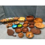 A collection of treen bowls in turned hardwood including fruit bowls, serving dishes, coconut bowls,