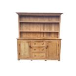 A Victorian pine farmhouse kitchen dresser, the delft rack with open shelves and tongue & grooved