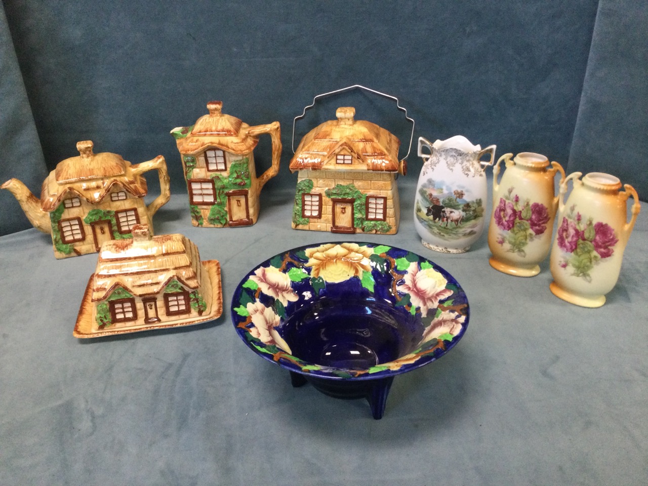 A four-piece Staffordshire cottage teaset with thatched covers; a Maling ribbed peony bowl on