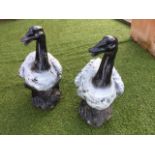 A pair of painted heavy cast iron ducks on naturalistic bases. (20in) (2)