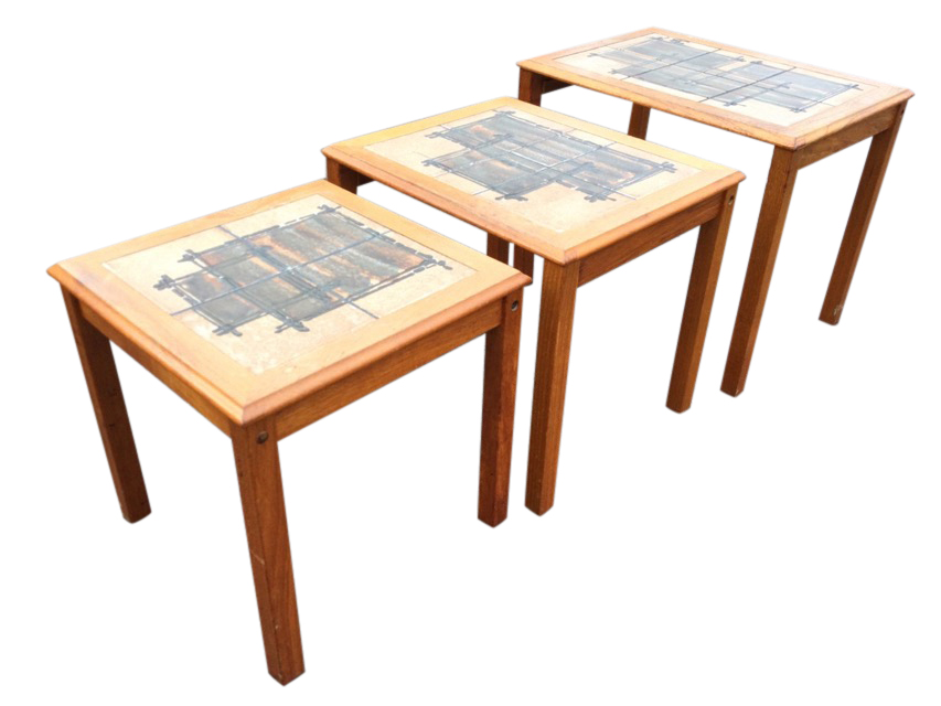 A nest of 70s Danish teak tables with art studio pottery tiles to rectangular moulded tops, raised