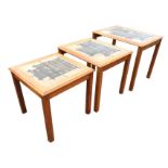 A nest of 70s Danish teak tables with art studio pottery tiles to rectangular moulded tops, raised
