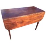 A wide nineteenth century mahogany pembroke table with rounded rule-jointed drop-leaves, the top