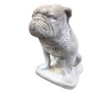 A composition stone bulldog, the grumpy animal sitting on its haunches with shaped plinth. (16.5in)