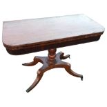 A nineteenth century mahogany turn-over-top tea table, the twin rounded tops above a ribbed apron,
