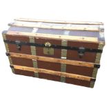 A domed top seamans chest with hardwood slats and metal mounts, having leather handles to ends,