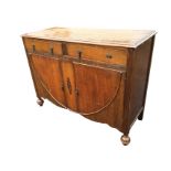 A 30s oak sideboard with rectangular moulded top above two frieze drawers framed by ribbed pilasters