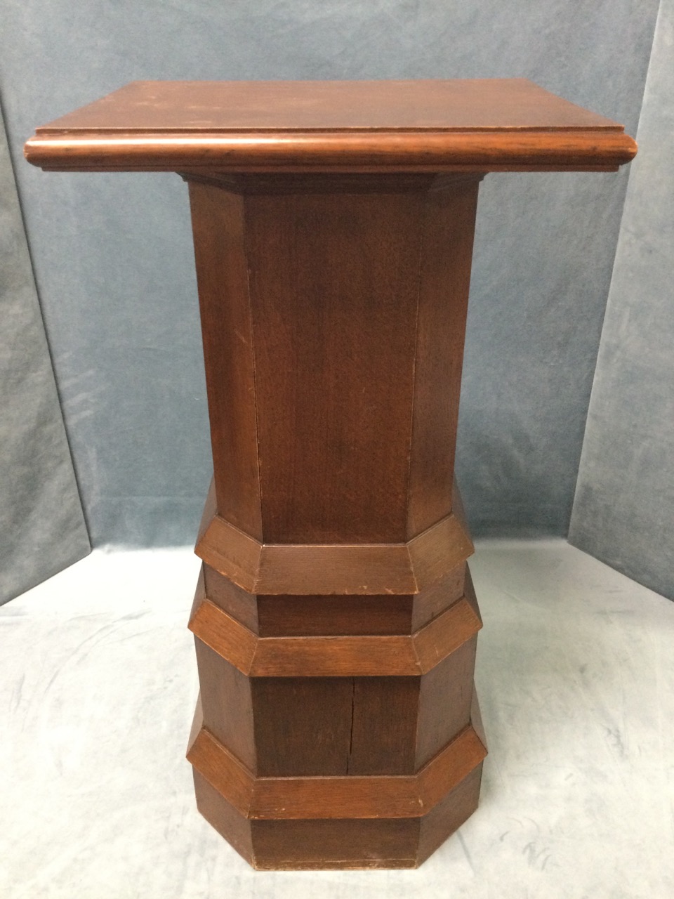 An oak lectern table or plantstand with rectangular moulded top on square canted column above an